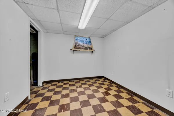 a view of a big room with a black white checkered floor