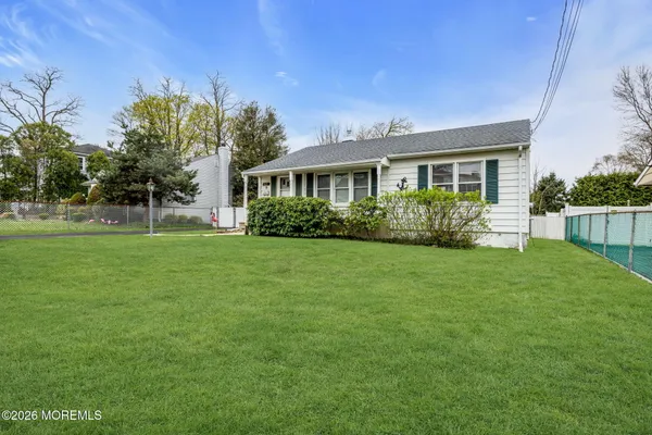 a front view of house with yard and green space