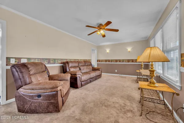 a living room with furniture and a chandelier