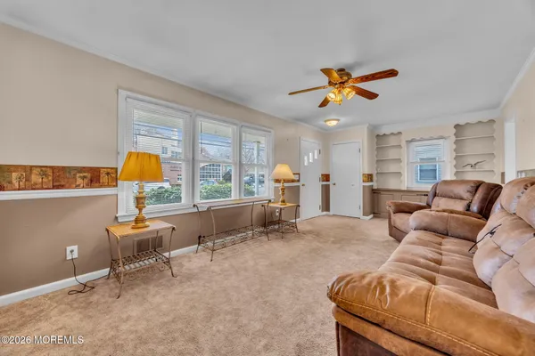 a living room with furniture and large window