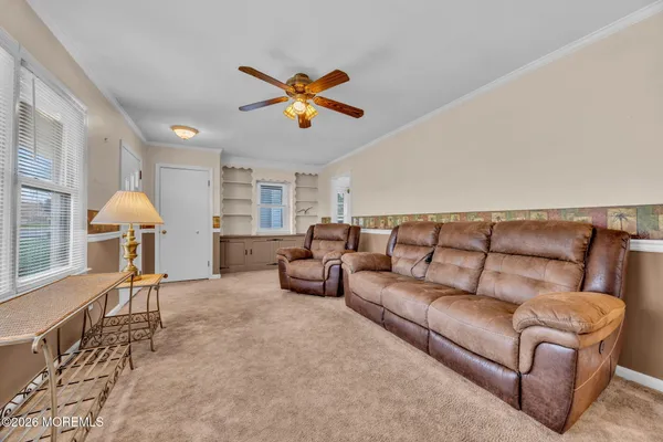 a living room with furniture and a chandelier
