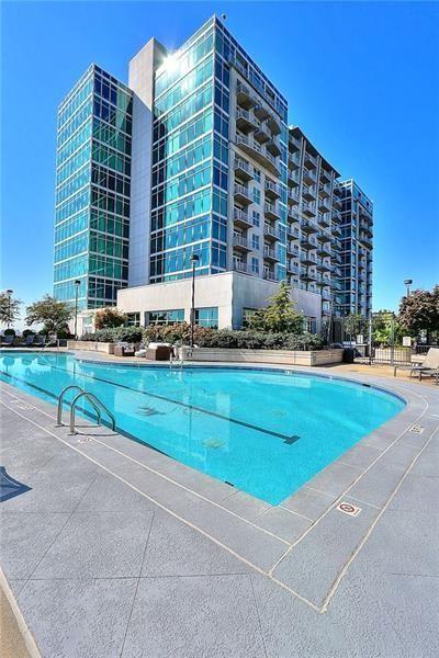 a view of a tall building next to a yard