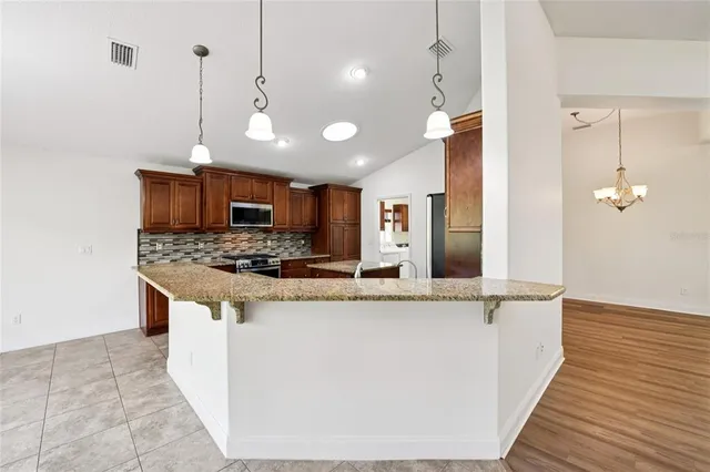 a large kitchen with stainless steel appliances kitchen island a large island in the center