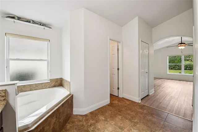 a bathroom with a granite countertop sink a mirror and a shower