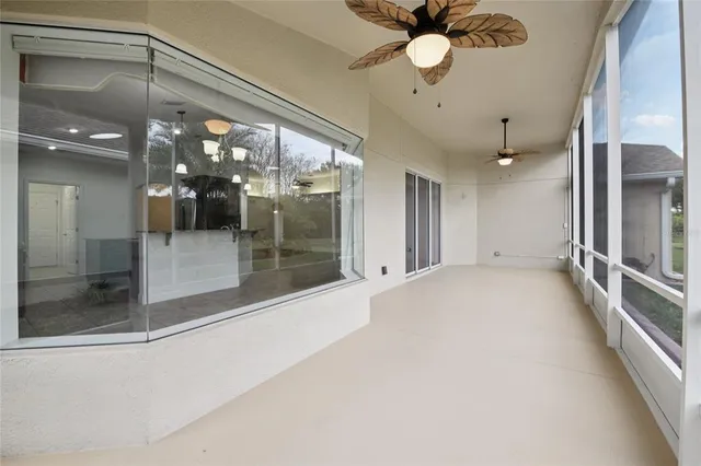 a view of a house with a yard and palm trees