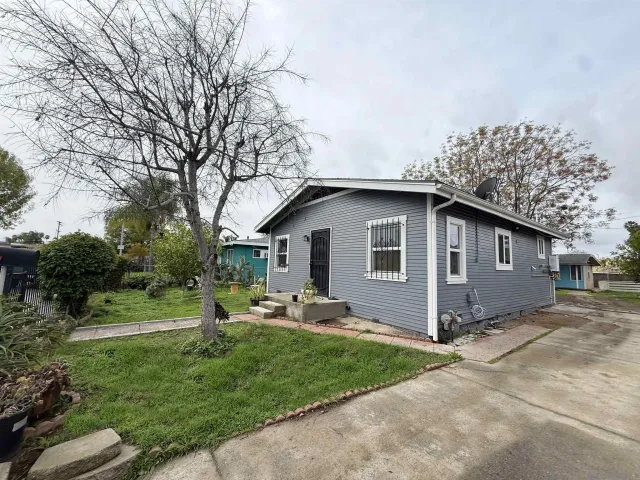 a backyard of a house with table and chairs