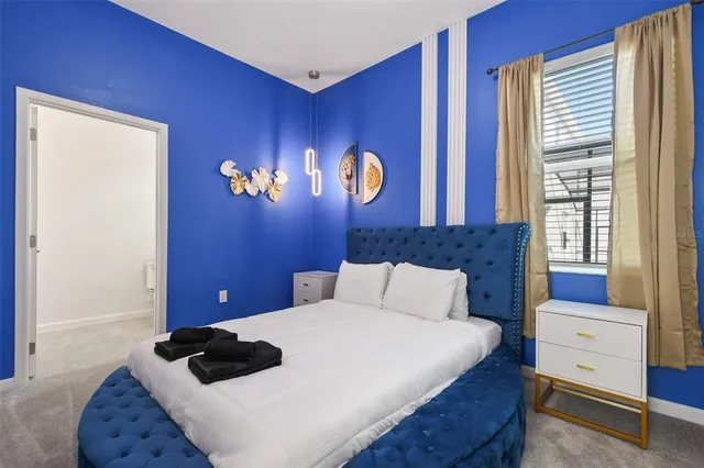 a bedroom with a bed and a window