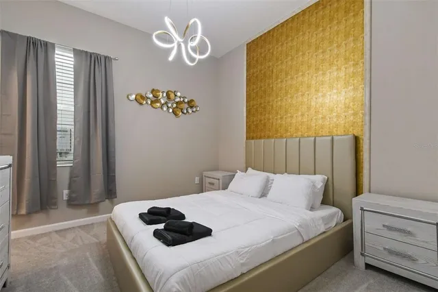 a bedroom with a bed and a chandelier