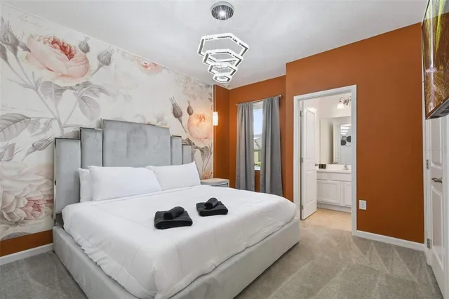 a living room with furniture fireplace and large windows