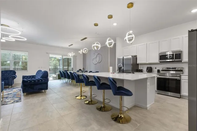 a living room with a fireplace and chandelier