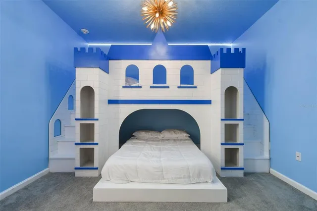 a bedroom with two beds and a painting on the wall