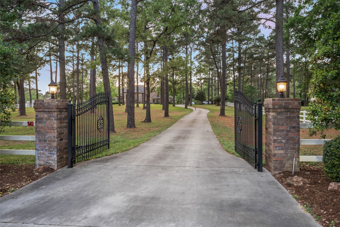 13222 Stonecrest Lane Conroe, TX 77302 - Photo 3 of 44 Private gate entry, winding drive up to the home.