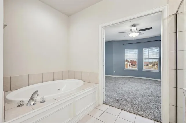 a bathroom with a bathtub and a shower