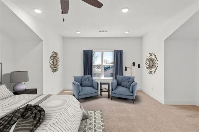 a bedroom with a bed and ceiling fan