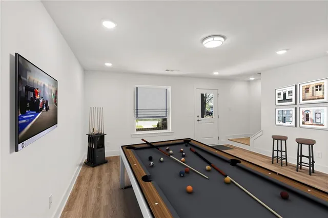a living room with furniture pool table and a window