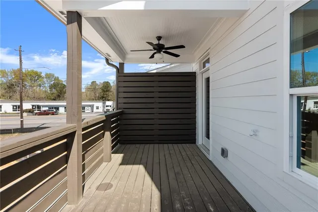 a view of a balcony with a floor to ceiling window with wooden floor