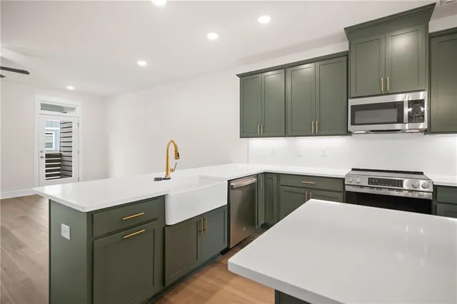 a kitchen with a sink and stainless steel appliances