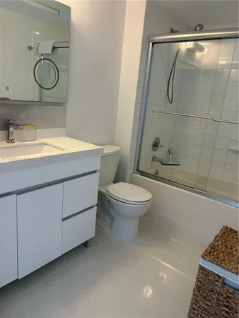 a bathroom with a toilet sink and shower