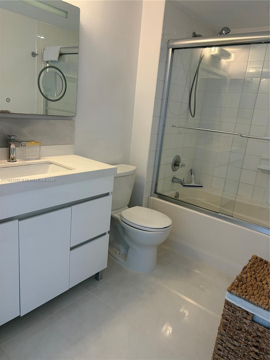 90 Alton Road, Unit 1007 Miami Beach, FL 33139 - Photo 12 of 16 a bathroom with a toilet sink and shower