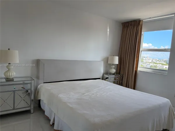 a bedroom with a bed and window