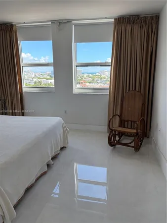 a bedroom with bed and a window