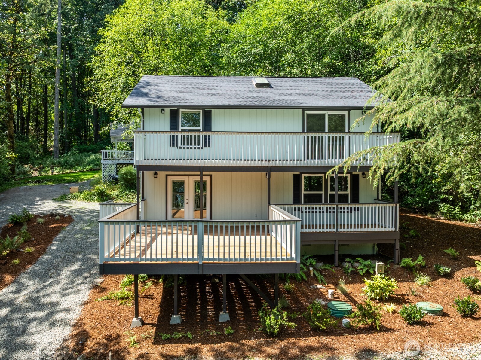 7605 Northeast Hidden Cove Road Bainbridge Island, WA 98110 - Photo 17 of 36 a view of a house with a deck