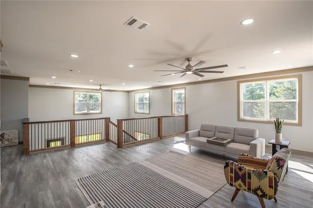 a living room with furniture and a wooden floor