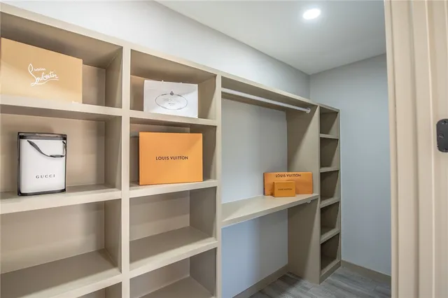 a bedroom with a large bed and a ceiling fan