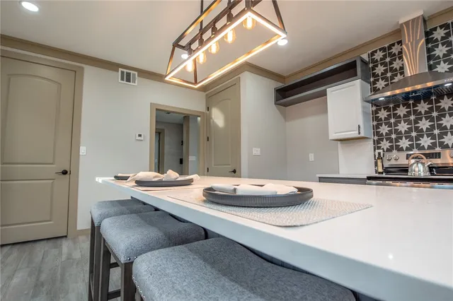 a large kitchen with lots of counter space and stainless steel appliances