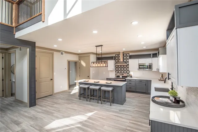a kitchen with a sink a window and cabinets
