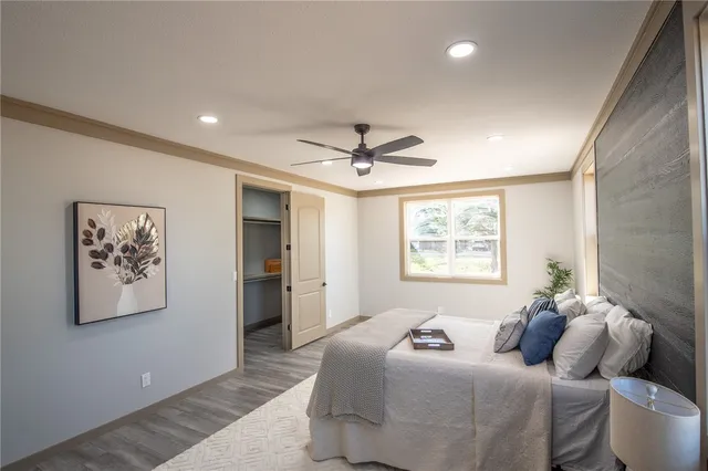 a bedroom with a bed and a large mirror