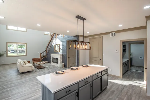 a view of living room with granite countertop furniture and wooden floor