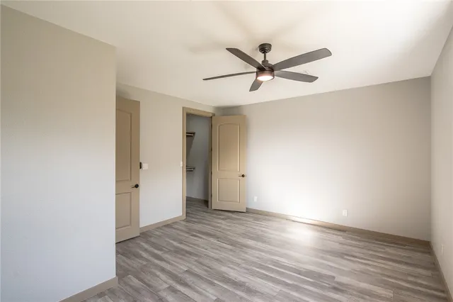 an empty room with wooden floor and closet