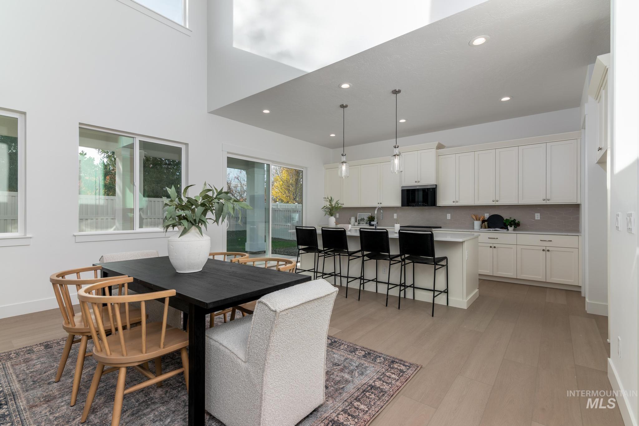5431 North Ebony Way Meridian, ID 83646 - Photo 5 of 13 Dining area featuring light wood-style floors, a high ceiling, and recessed lighting