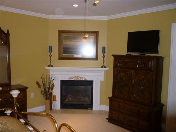 218 Rangeway Road, Unit 271 Billerica, MA 01862 - Photo 16 of 30 a living room with a fireplace a flat screen tv and a fireplace