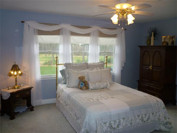218 Rangeway Road, Unit 271 Billerica, MA 01862 - Photo 22 of 30 a bedroom with a bed and a chandelier
