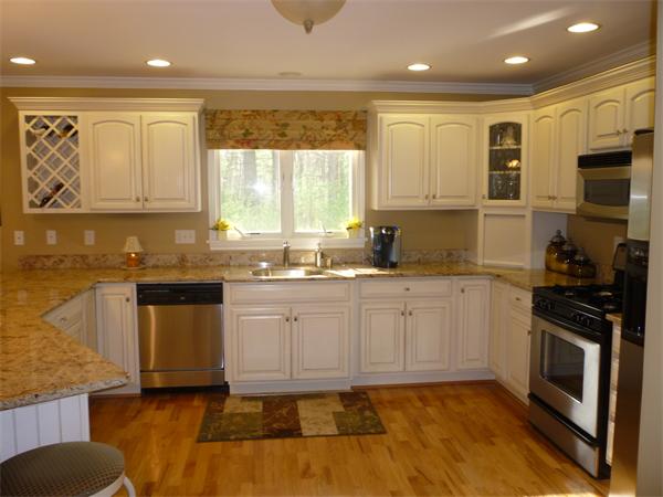 218 Rangeway Road, Unit 271 Billerica, MA 01862 - Photo 7 of 30 a kitchen with stainless steel appliances granite countertop a stove a sink and a microwave