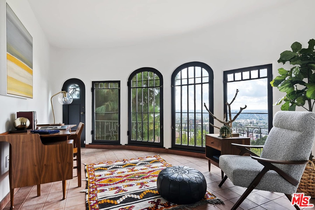 8142 Laurel View Drive Los Angeles, CA 90069 - Photo 12 of 41 a living room with furniture fireplace and a large window