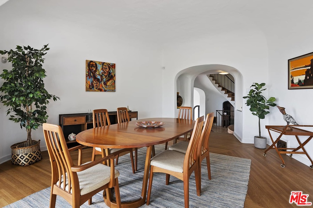 8142 Laurel View Drive Los Angeles, CA 90069 - Photo 14 of 41 a view of a dining room with furniture and wooden floor