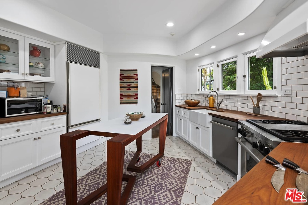 8142 Laurel View Drive Los Angeles, CA 90069 - Photo 17 of 41 a kitchen with stainless steel appliances granite countertop a stove a sink and a refrigerator