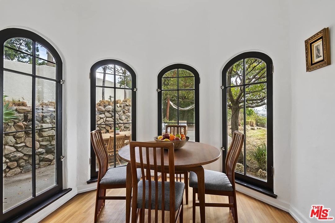 8142 Laurel View Drive Los Angeles, CA 90069 - Photo 19 of 41 a view of a dining room with furniture window and wooden floor