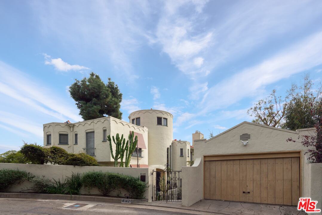 8142 Laurel View Drive Los Angeles, CA 90069 - Photo 3 of 41 a front view of a house with a yard