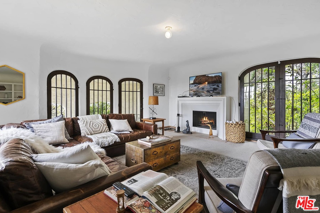 8142 Laurel View Drive Los Angeles, CA 90069 - Photo 23 of 41 a living room with furniture fireplace and a large window