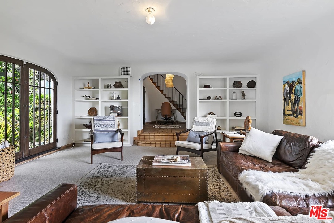 8142 Laurel View Drive Los Angeles, CA 90069 - Photo 24 of 41 a living room with furniture fireplace and a large window