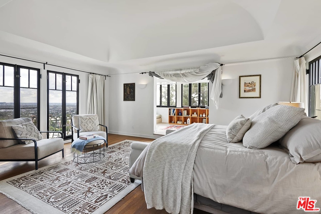 8142 Laurel View Drive Los Angeles, CA 90069 - Photo 26 of 41 a bedroom with a large bed couch and a window
