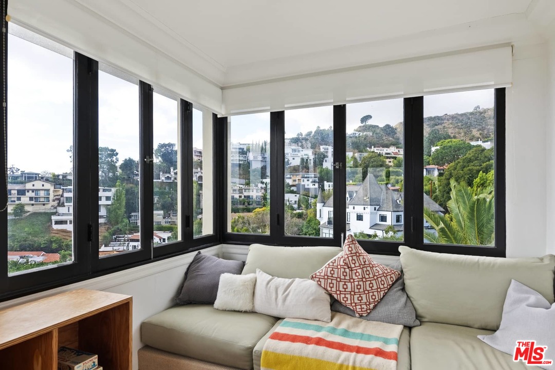 8142 Laurel View Drive Los Angeles, CA 90069 - Photo 31 of 41 a living room with furniture and a large window