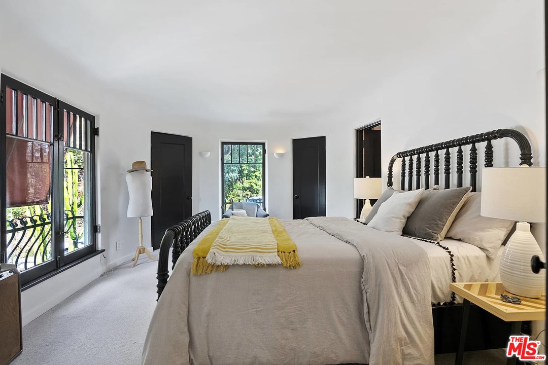 8142 Laurel View Drive Los Angeles, CA 90069 - Photo 34 of 41 a bedroom with a bed and wooden floor