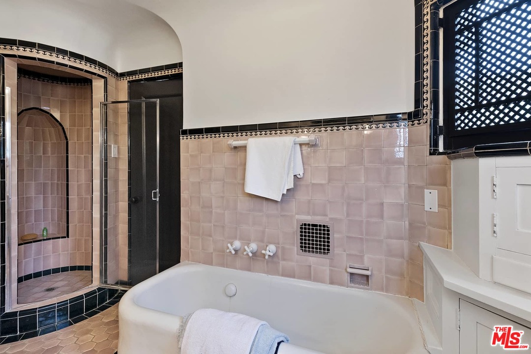 8142 Laurel View Drive Los Angeles, CA 90069 - Photo 36 of 41 a bathroom with a bathtub and shower