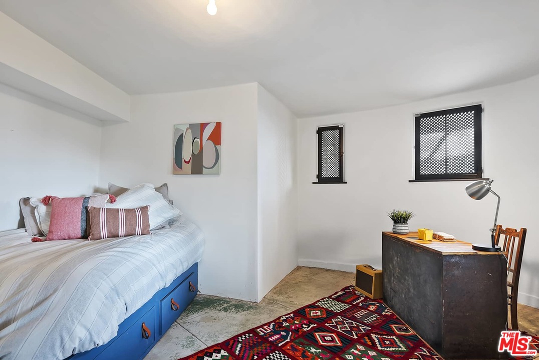 8142 Laurel View Drive Los Angeles, CA 90069 - Photo 40 of 41 a bedroom with a bed and wooden floor