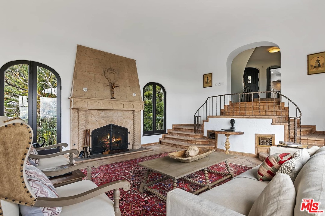 8142 Laurel View Drive Los Angeles, CA 90069 - Photo 8 of 41 a living room with furniture a fireplace and a large window